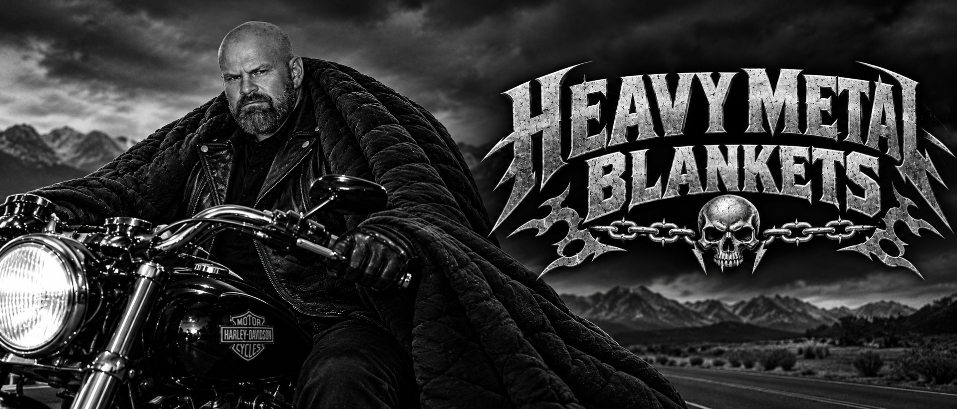 Bearded rider on a motorcycle wrapped in a black Heavy Metal Blanket beside the chrome Heavy Metal Blankets logo